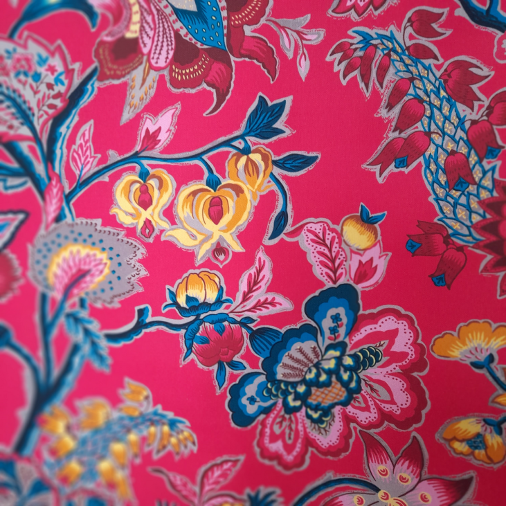 Romy fabric by Maison Thevenon has a raspberry background and beautiful, bright colors, and is sold by the meter and in coupons. Made in France.