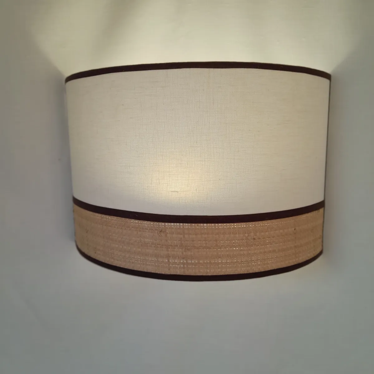 Design and contemporary Raphia wall lamp and ivory linen trimmed with wenge-coloured braid.