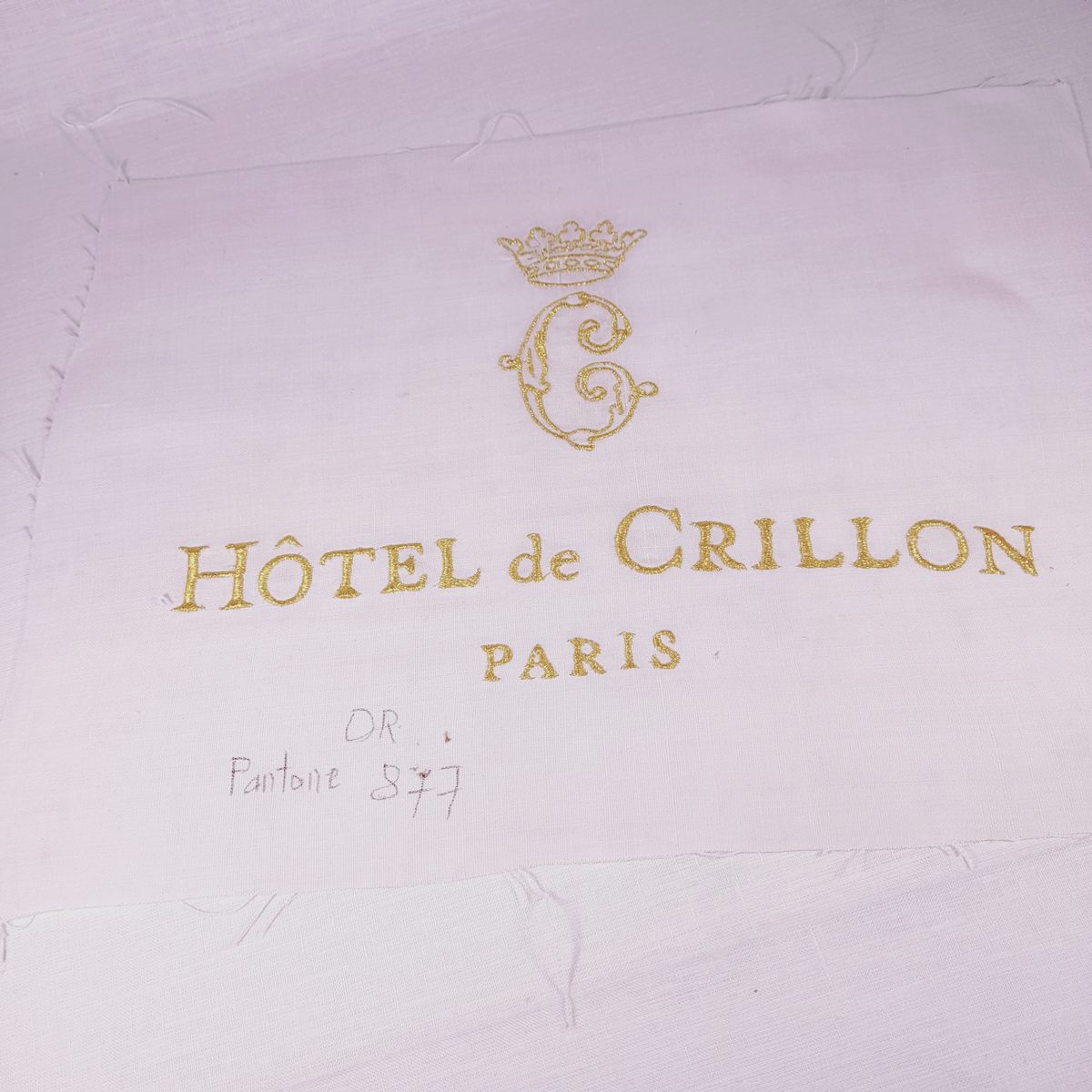 Embroidery of the logo in gold thread for a lampshade for the boutique at the Hôtel de Crillon in Paris