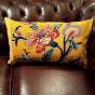 Magnifique coussin rectangulaire Romy ocre jaune en coton imprimé d'un motif floral coloré et velours uni framboise.
